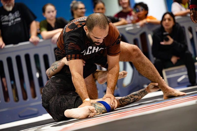 A no-gi competitor controls his opponent's legs while working to pass.