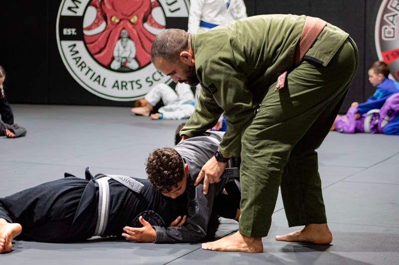 An instructor coaching a student on the ground